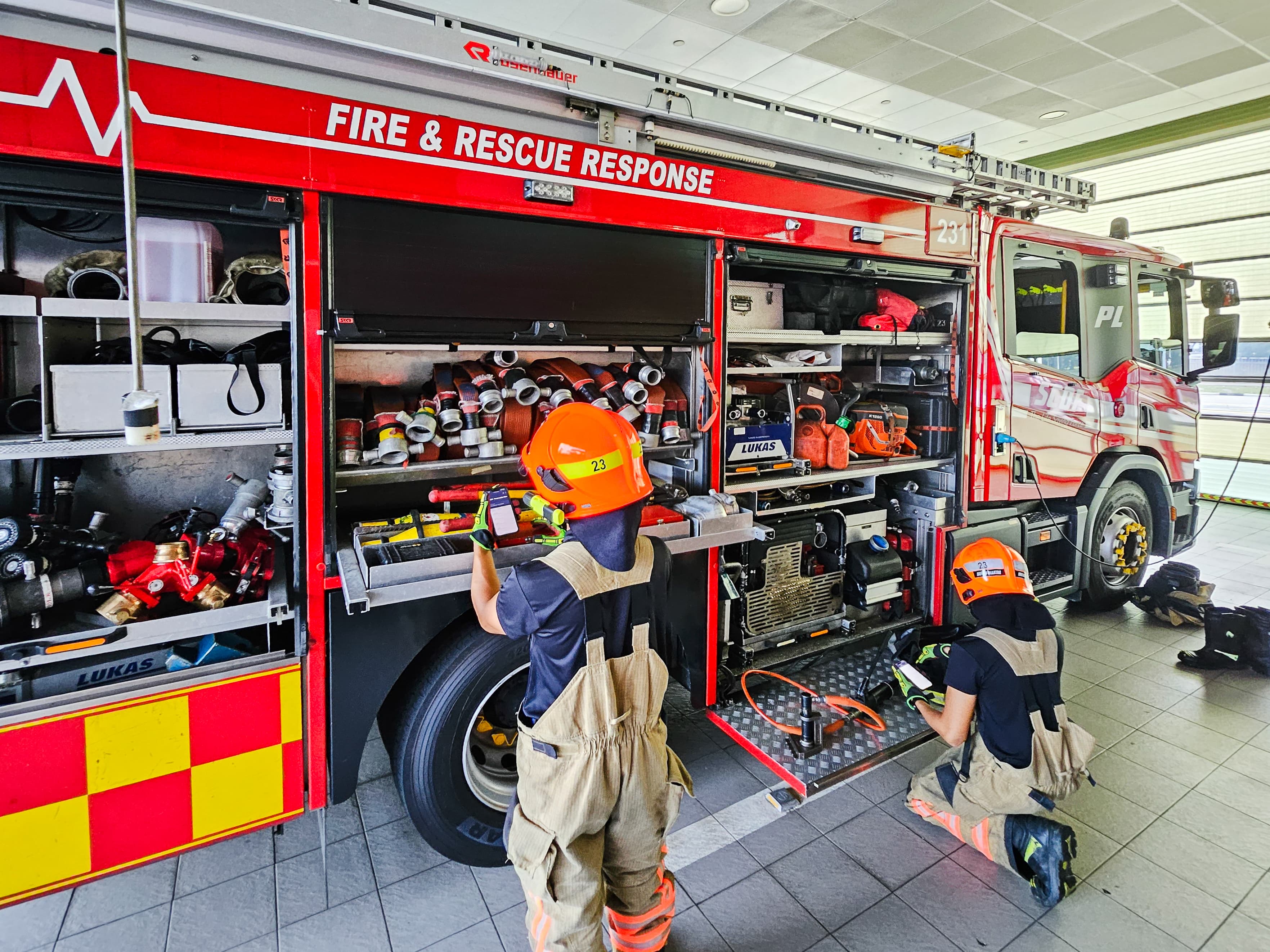 Officers checking their equipment at the fire station