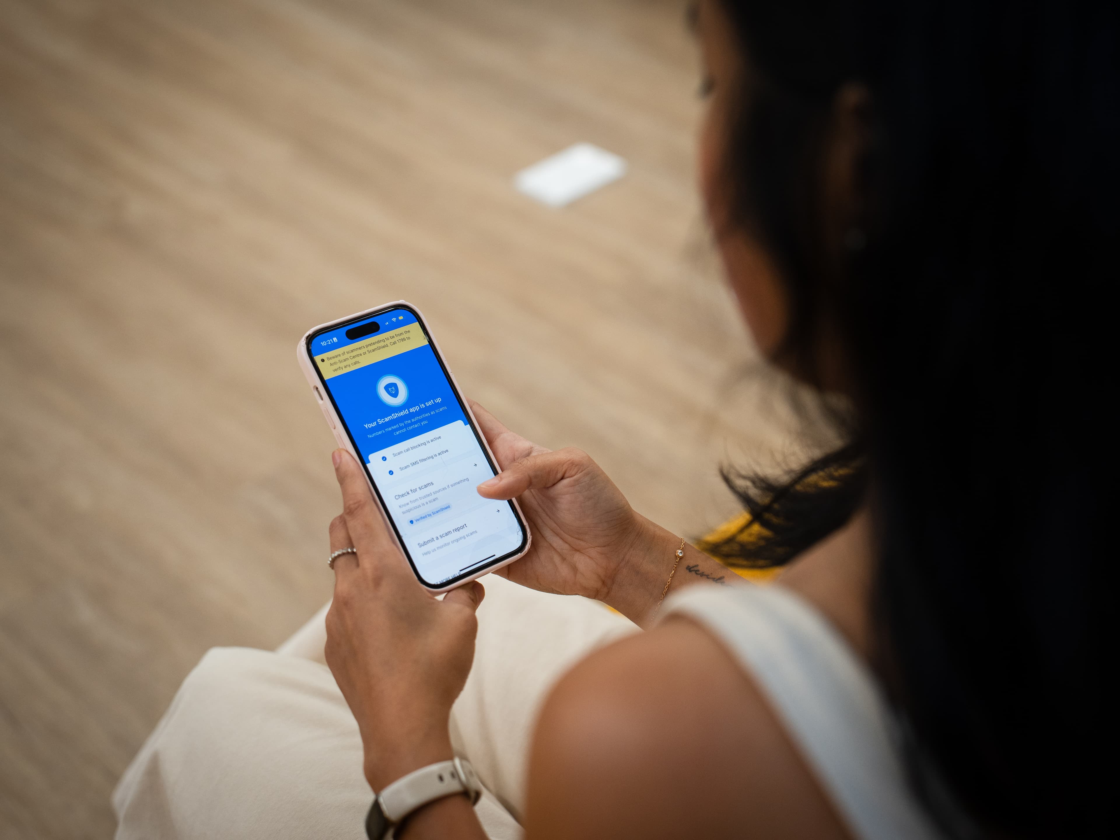 Lady using the ScamShield app